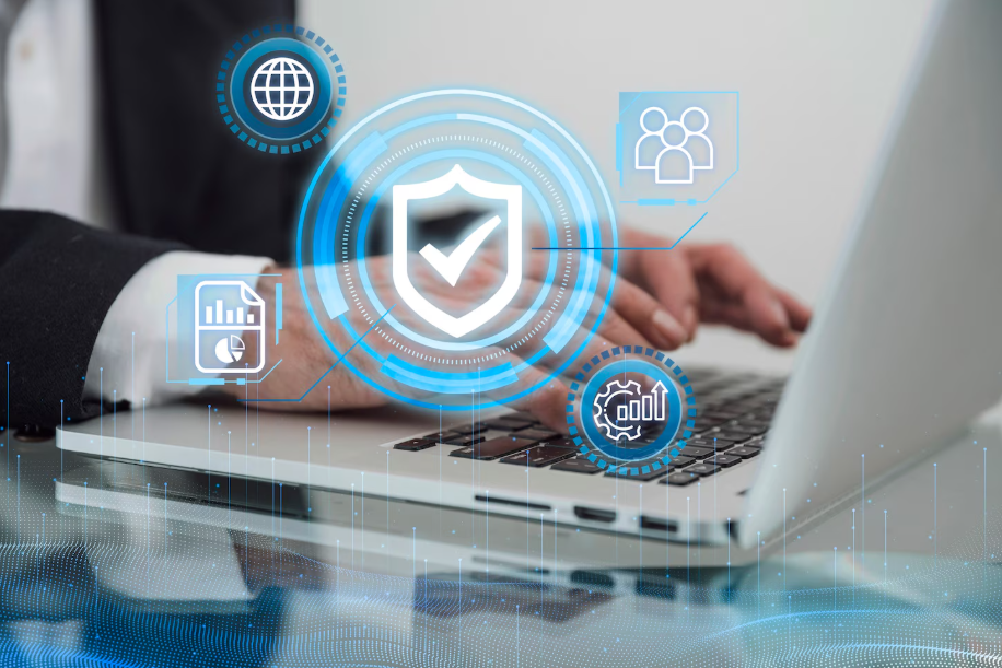 Businessperson typing on laptop with digital privacy and data protection icons overlay