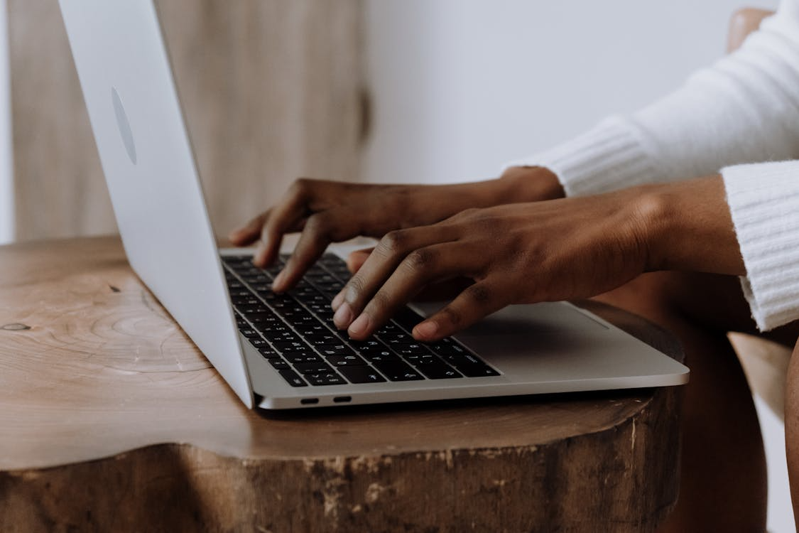 Person using a laptop to apply practical keyboard shortcuts for daily tasks.