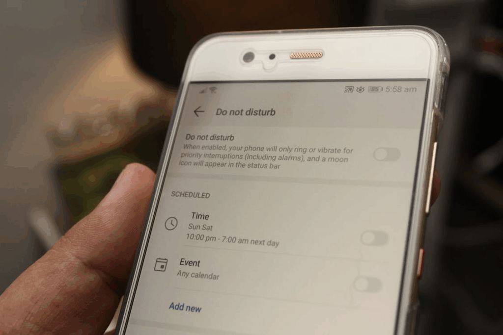 Close-up of a smartphone with Do Not Disturb mode scheduled, showing a digital minimalism strategy for reducing notifications