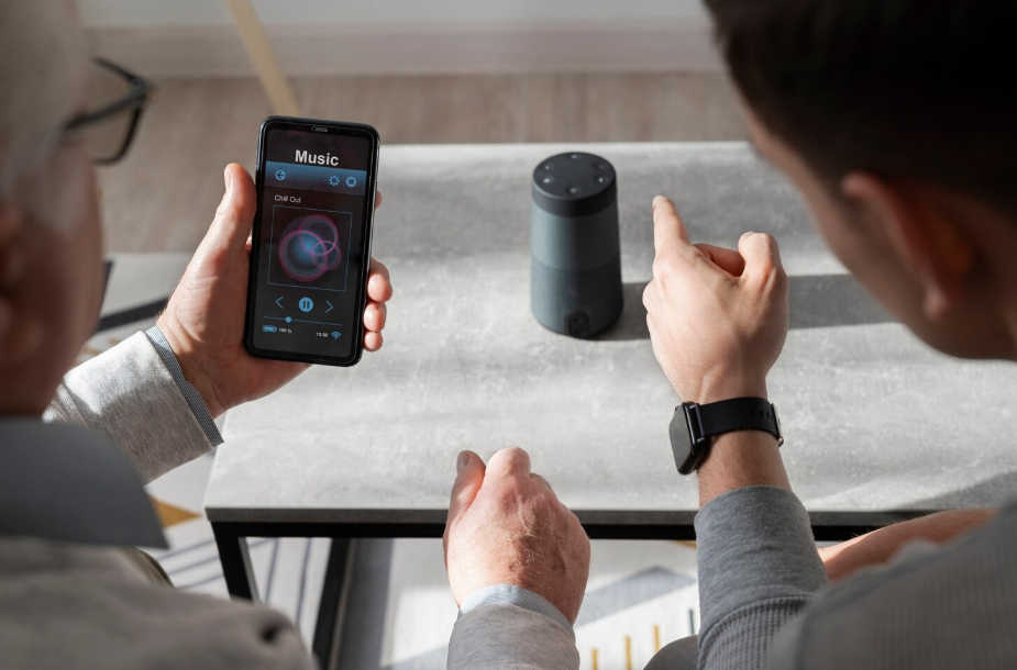 Two people using smartphone app and smart speaker